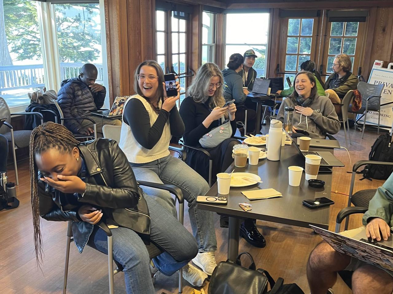 a group of hack the hackathon participants laughing.