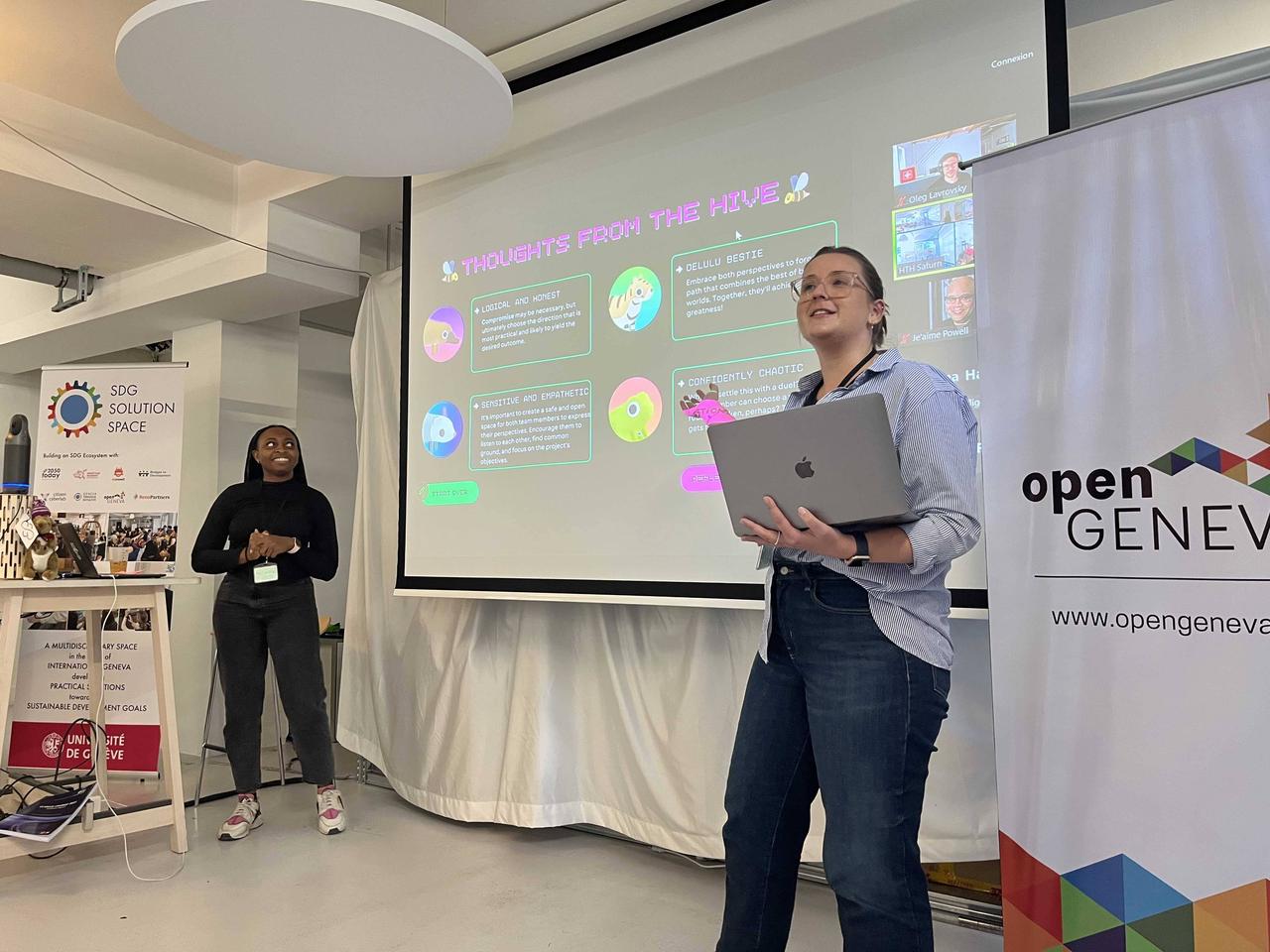 A woman standing in front of a screen showing a hack outcome